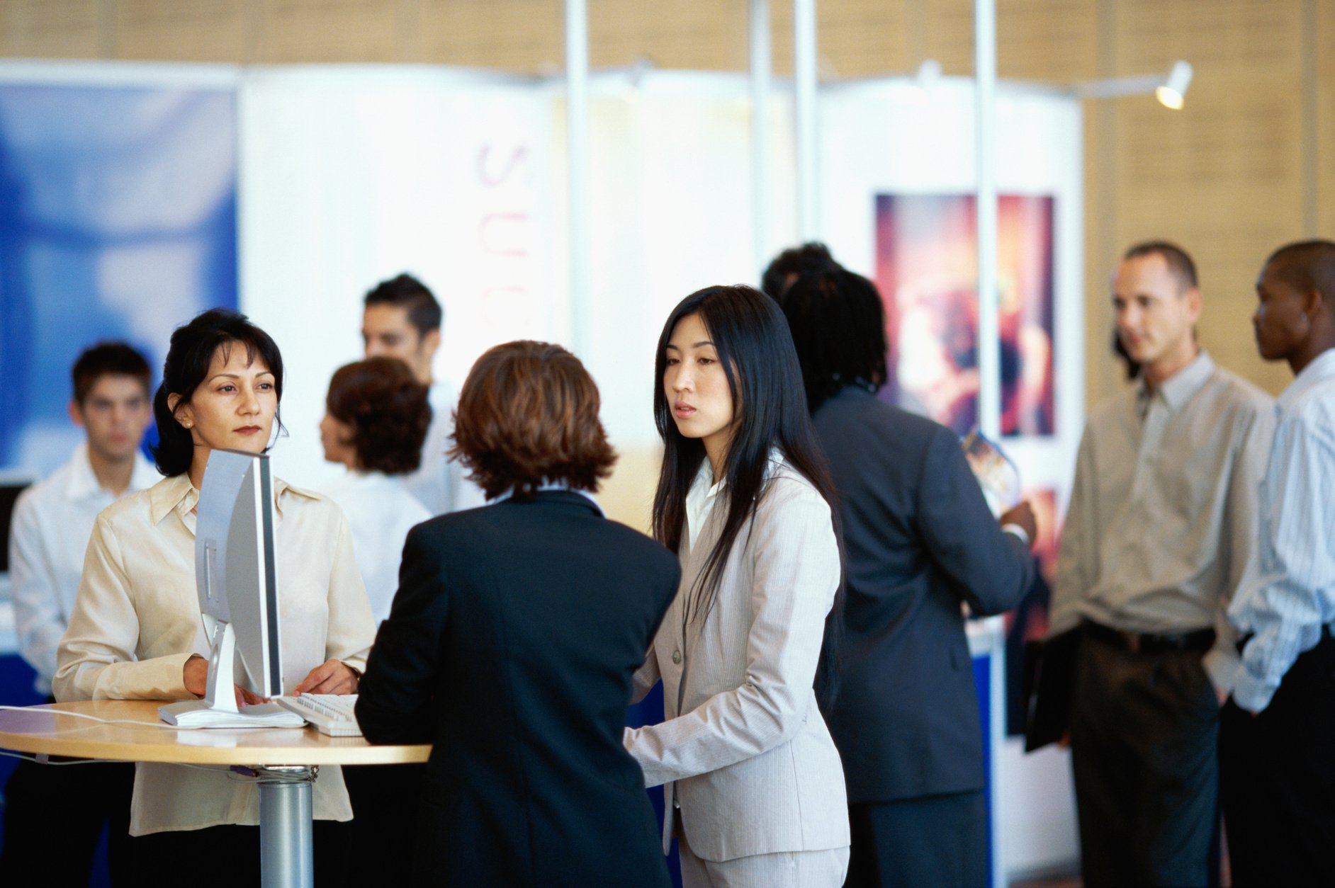 three businesswomen discussing at an exhibition